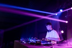 Concentrated DJ performing on a night club