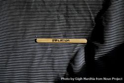 The word “inflation” written on wooden stick 4B6AW4