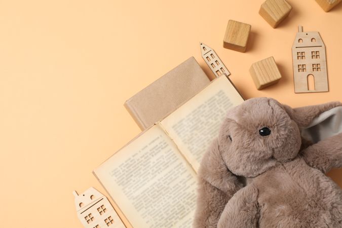 A children's book with toys on a beige background.