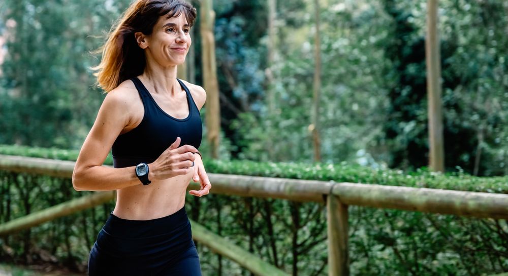 Woman running through a park