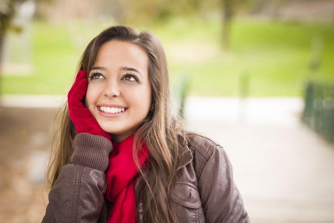 Portrait of Woman Wearing Red Scarf and Mittens Outside