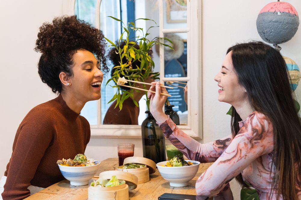 Friendly diverse women eating in restaurant together