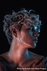 Side view portrait of topless blonde man with UV paint on his face against dark background 5Rz2B5