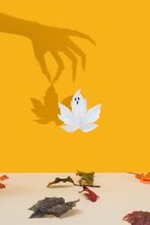 Shadow of a hand holding a leaf