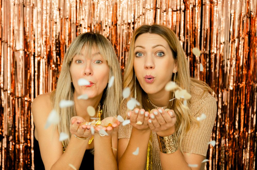 Charming women with confetti on party