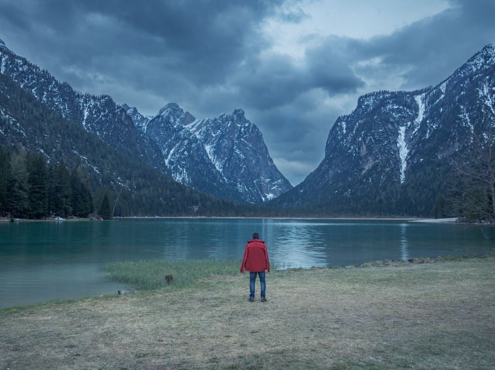 Male photographer near mountains and lake