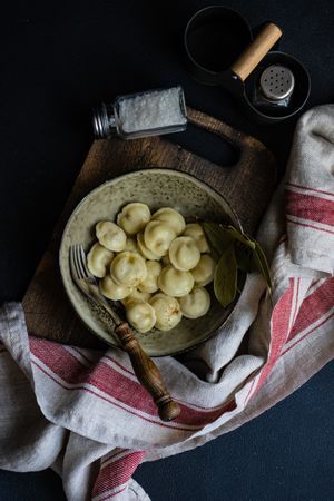 Top view of bowl of traditional Russian dumplings in ceramic bowl