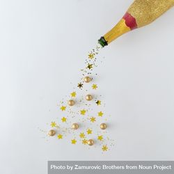 Gold champagne bottle pouring glitter into the shape of a Christmas tree 4MgGl0