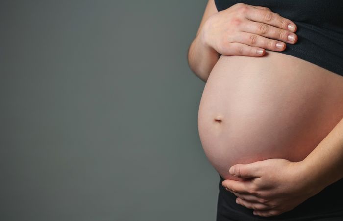 Pregnant woman caressing her belly