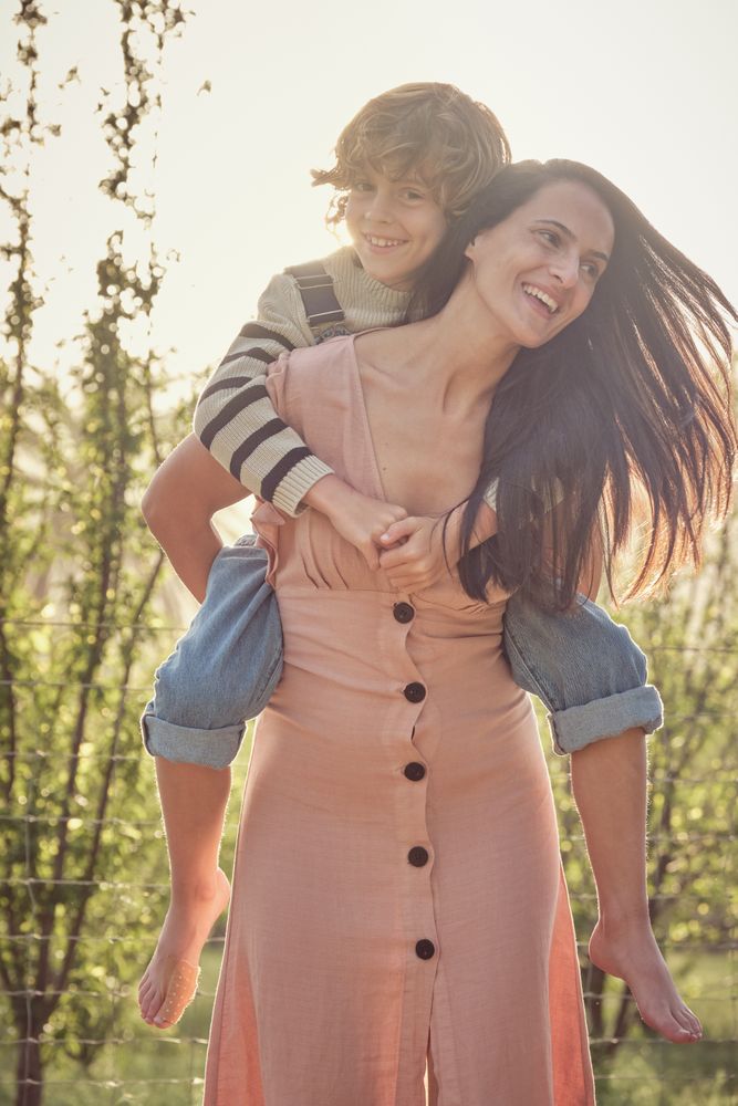 Happy woman with son in park