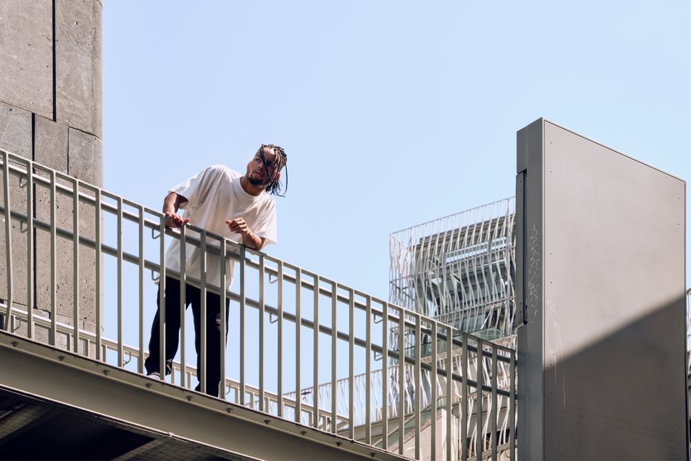 Black male standing on bridge