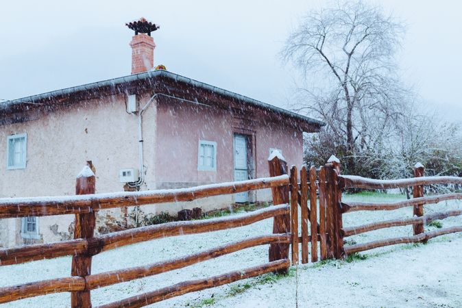 Old building and wooden fence in winter