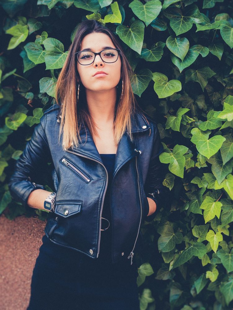 Serious woman near bush