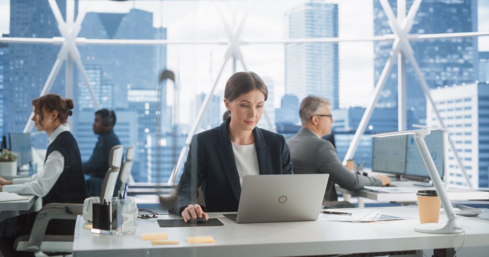 Professional Female Business Development Manager Typing On Laptop Computer In Bright Skyscraper Office In Downtown.