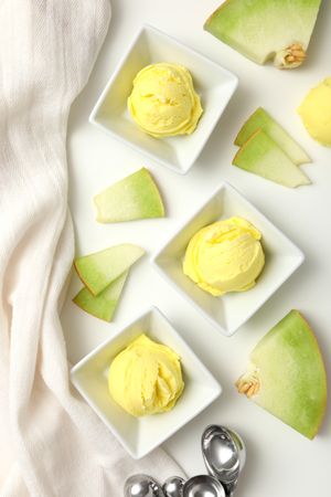 Ice cream scoops with slices of fresh melon