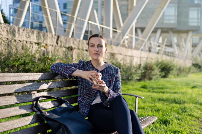 Businesswoman drinking on city street