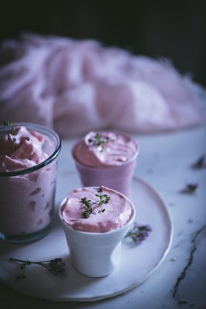 tasty glasses of strawberry mousse on a table with flowers