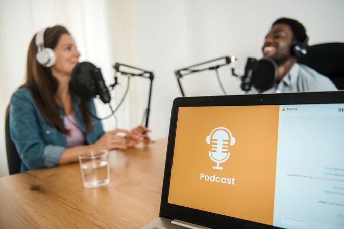 Laptop against diverse colleagues recording podcast