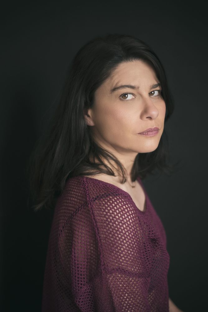 Side view portrait of mature woman in purple shirt