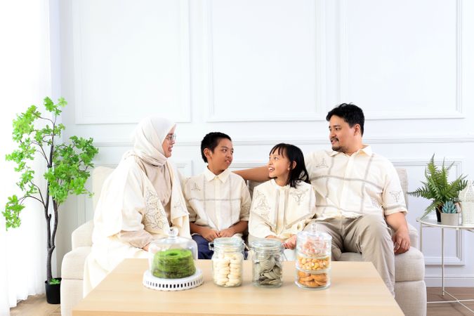 Family Sitting at Living Room Wearing Baju Lebaran Couple