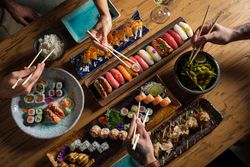 Unrecognizable people eating traditional Asian food