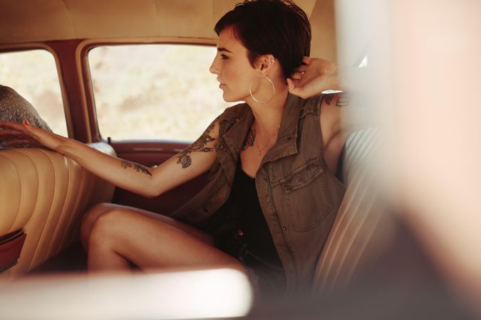 Female traveling by a vintage car