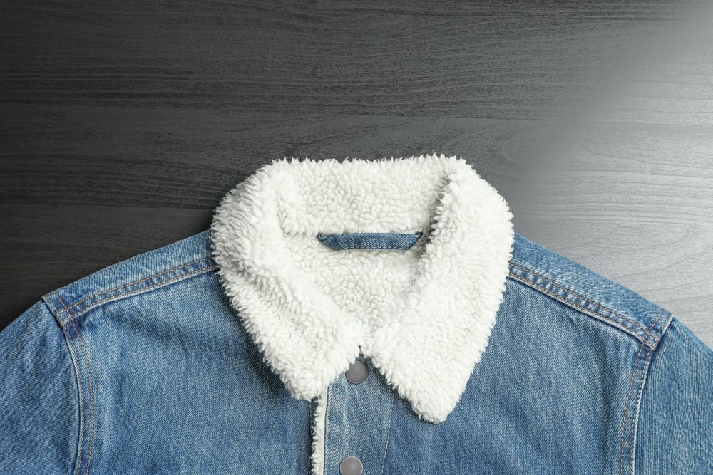 Denim jacket on background, space for text