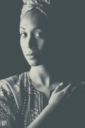 Black' woman thoughtfully looking at camera