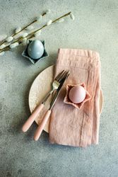 Festive Easter place setting decorated with pastel pink and blue eggs and pussy willow