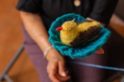 Older woman's knitting masterpiece.