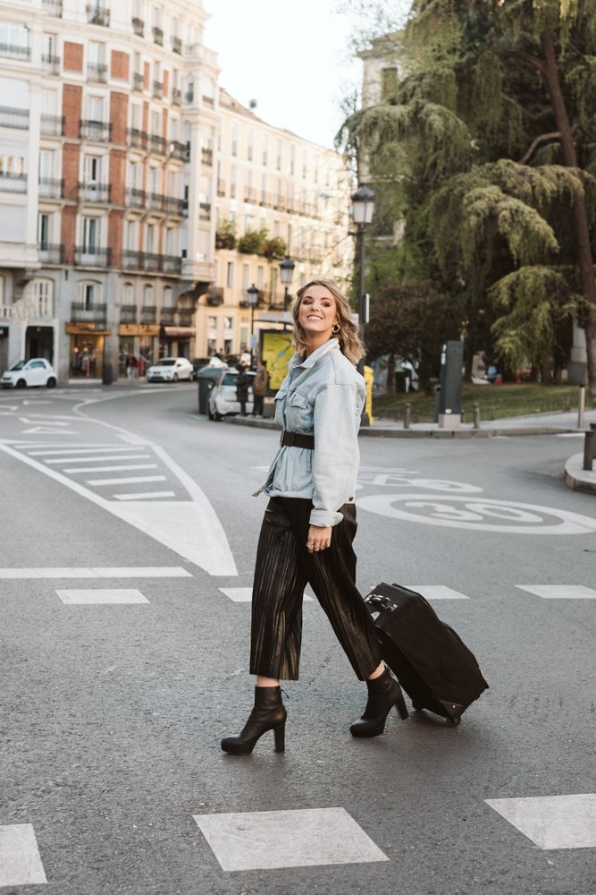 Cheerful female tourist crossing street