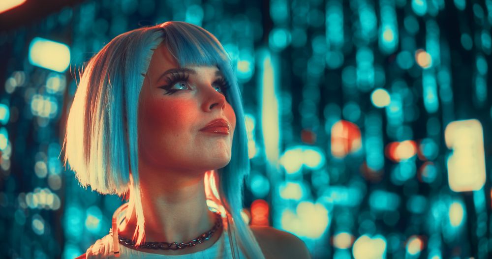Young Female with Blue Hair Wandering Around a Futuristic Urban Center with Neon Lights and Artificial Intelligence Technology