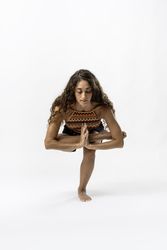 Woman Demonstrating Advanced Yoga Balance and Concentration in a Deep Squat