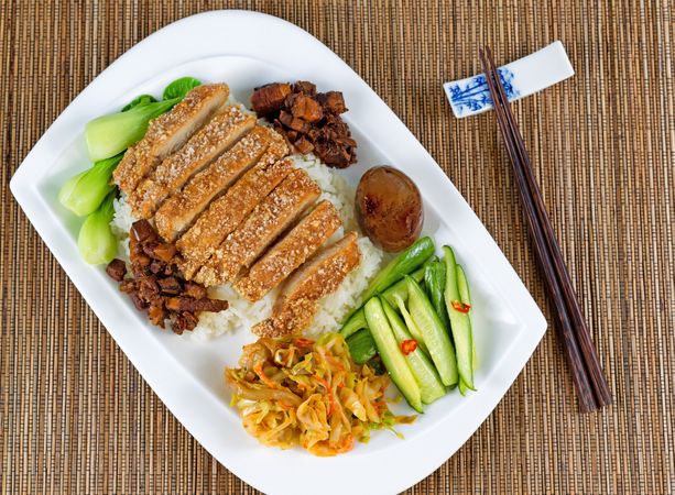 Fried bread coated pork slice dish and vegetables on plate