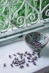 Dried flower buds and bowl near window