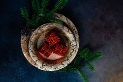 Holiday table setting with decorative gift boxes and fir branch
