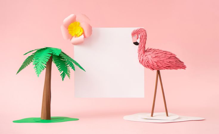 Palm tree and flamingo made of paper on pink background
