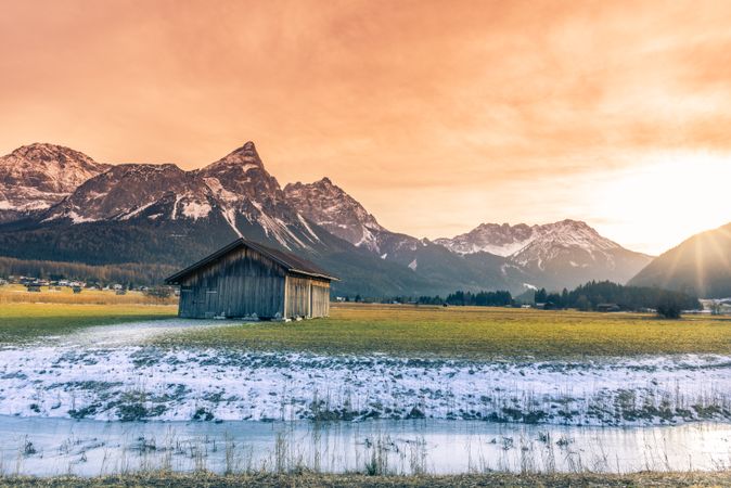 Wooden barn and alpine snowy scenery