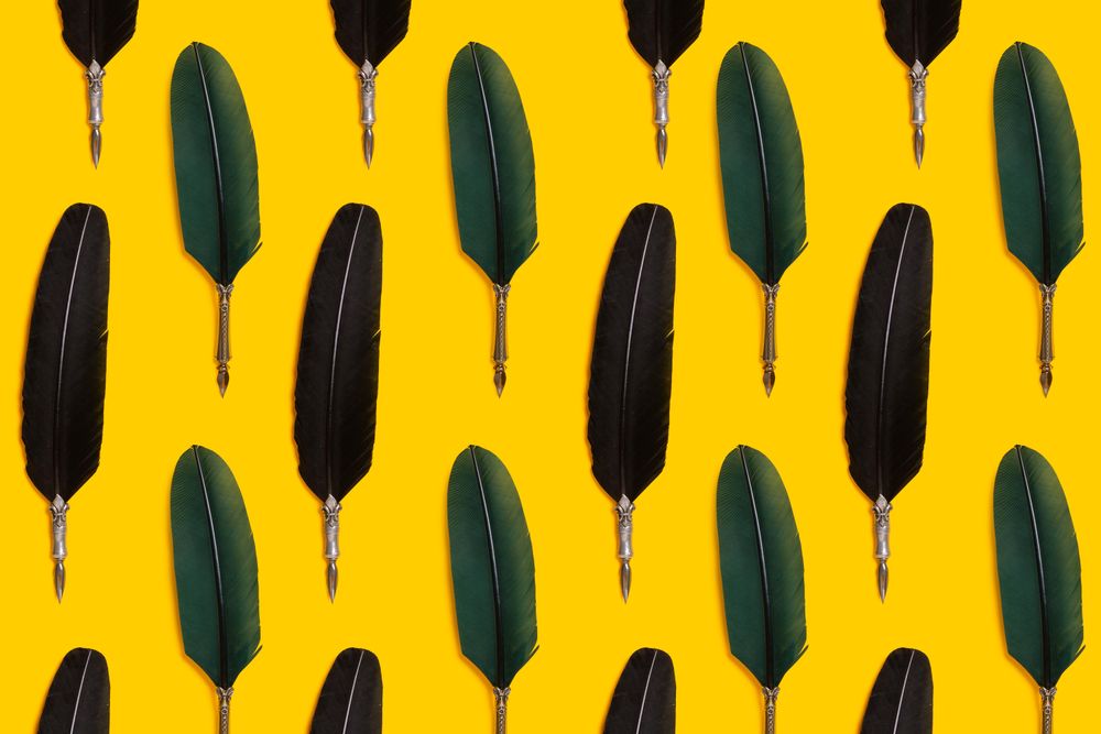 Green quill pens  on yellow background