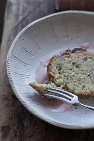 Delicious orange cake with poppy seeds and creme on plate