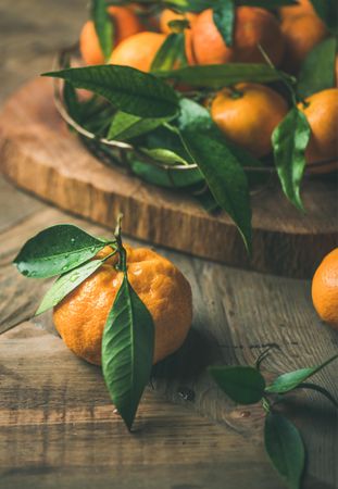 Freshly picked tangerines with leaves on wooden table