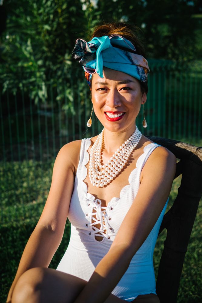 Young elegant Chinese woman sunbathing