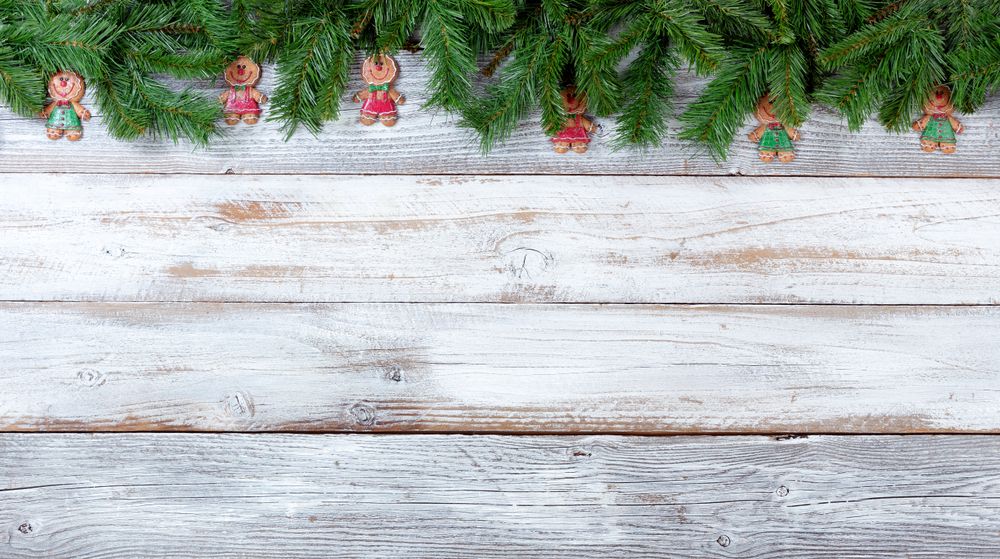 Christmas evergreen branches and cookies on vintage wooden planks