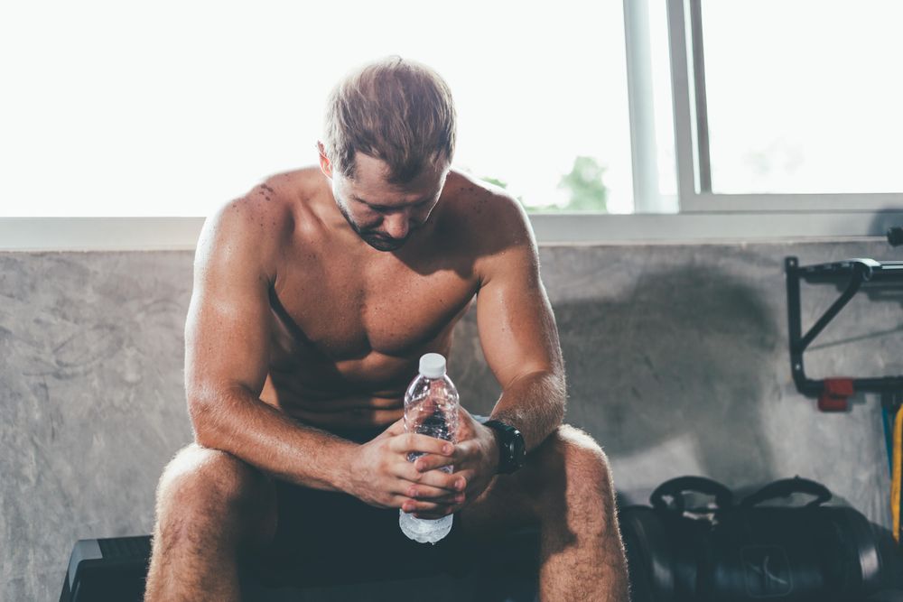 Athletic man resting after exercise at the gym