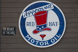 Signs on the side of, and leaning against, a small repair shop in Stevensville, Michigan