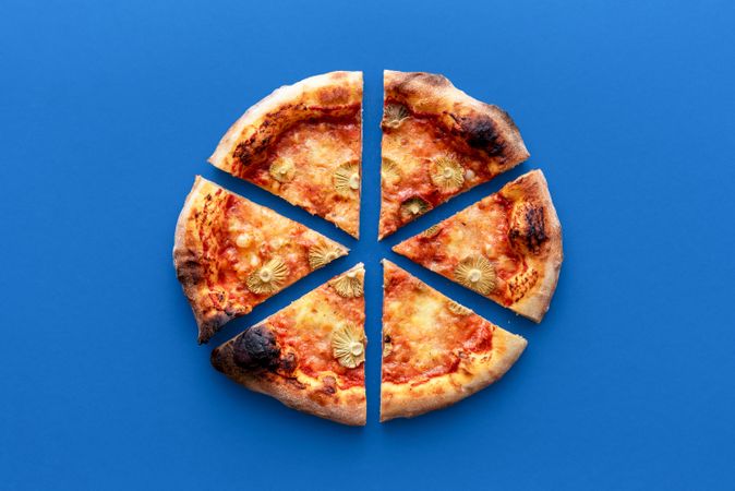 Homemade vegetarian pizza above view on a blue background