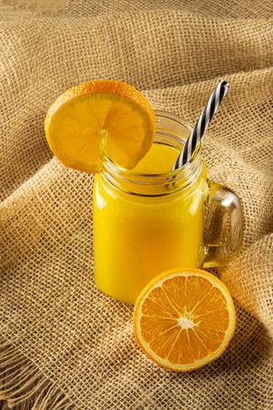 Glass with orange juice on the table.