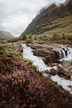 Mountain river with stones on daytime