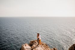 Serene lovers embracing on rock