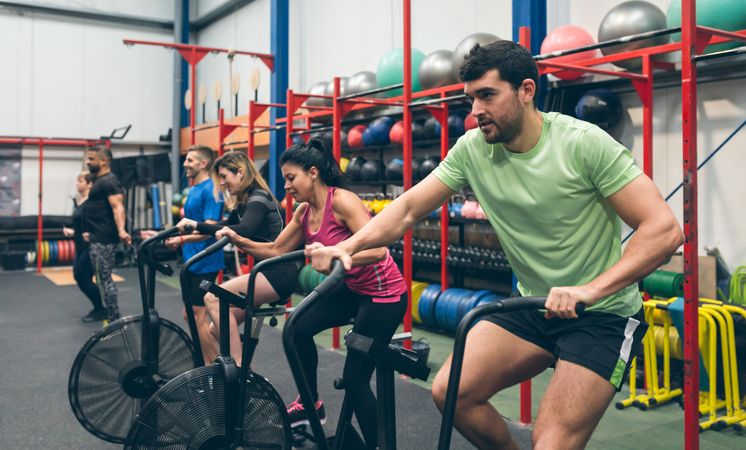 Athletes doing air bike indoor